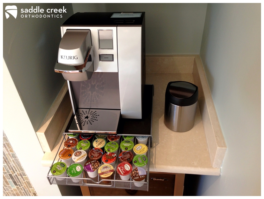 Close up view of Keurig coffee maker and Simple Human countertop trash can